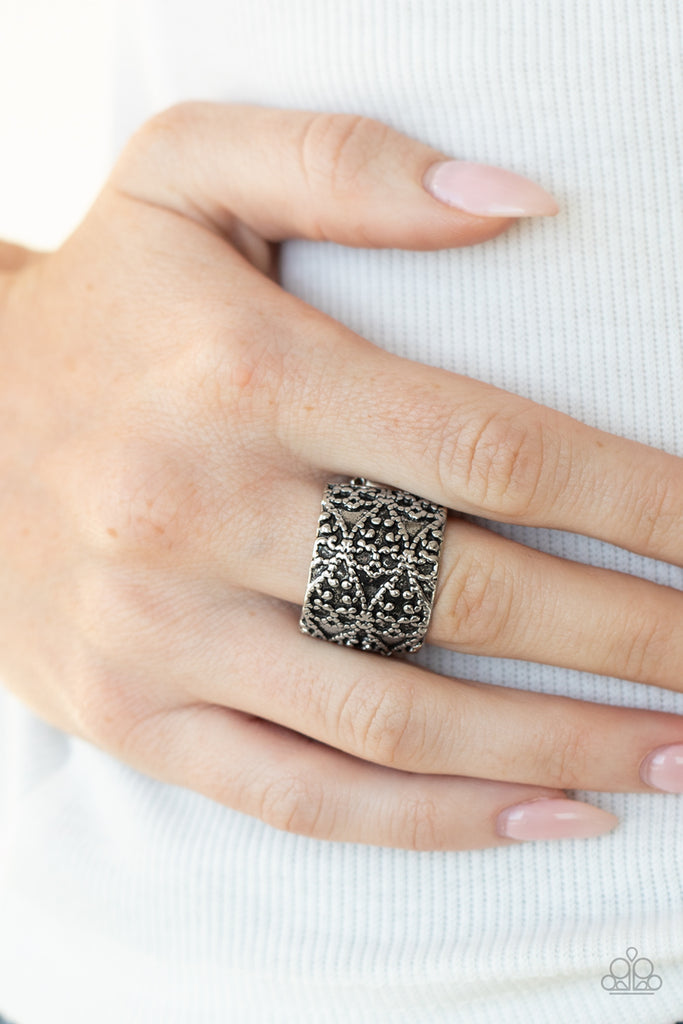 Studded in an ornate pattern, a thick silver band curls around the finger for a rustic look. Features a stretchy band for a flexible fit.  Sold as one individual ring.  