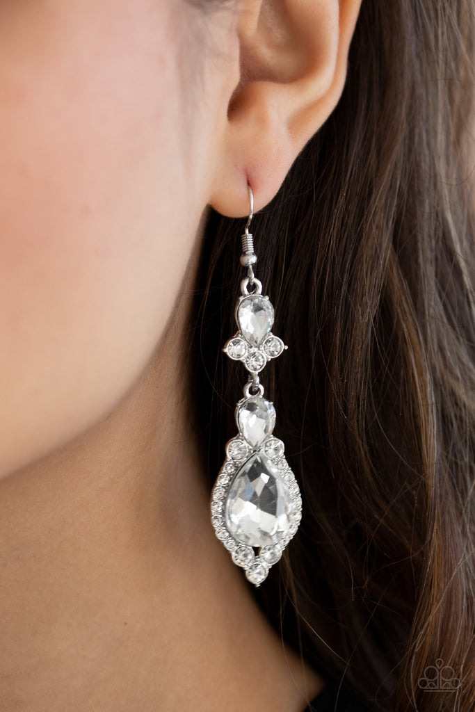 Encased in sleek silver frames, a sparkly series of round and teardrop white rhinestones flawlessly stack into a timelessly twinkly lure for a jaw-dropping look. Earring attaches to a standard fishhook fitting.  Sold as one pair of earrings.