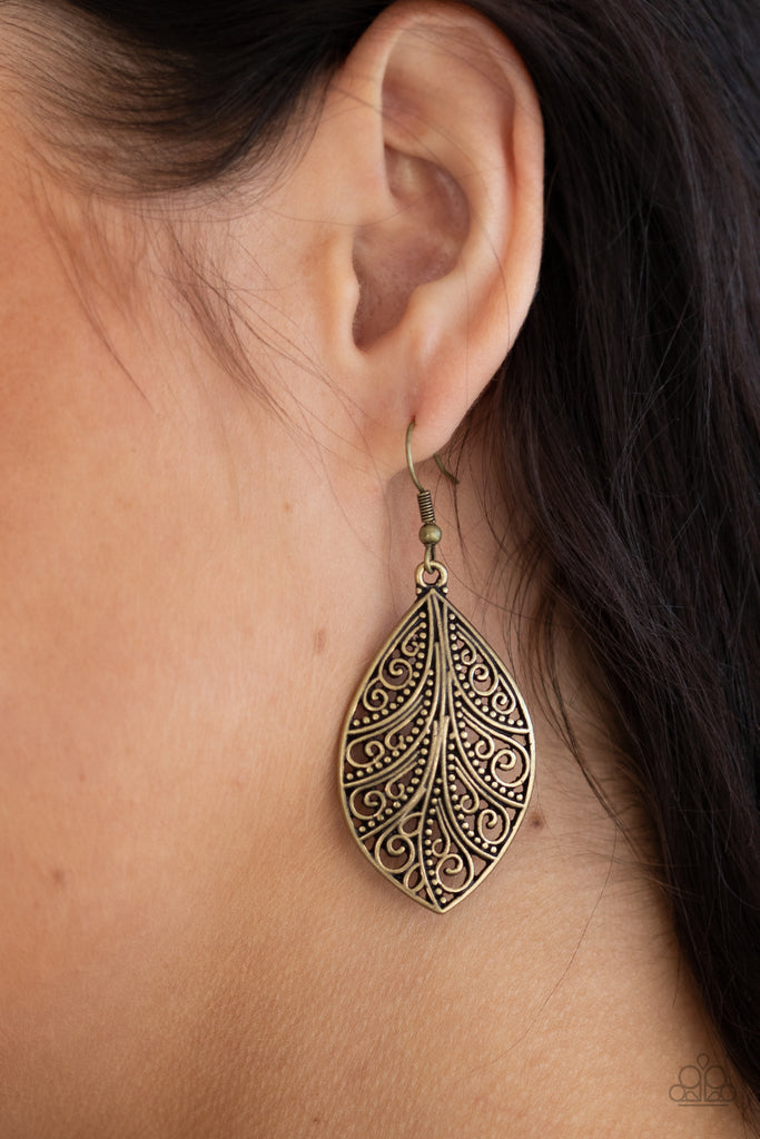 Smooth and studded vine-like filigree swirls across the front of a brass frame, creating a whimsical piece. Earring attaches to a standard fishhook fitting.  Sold as one pair of earrings.