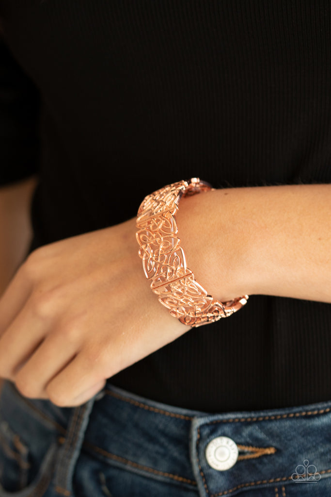 Shiny copper filigree filled frames are threaded along stretchy bands around the wrist, creating a whimsical centerpiece.  Sold as one individual bracelet.