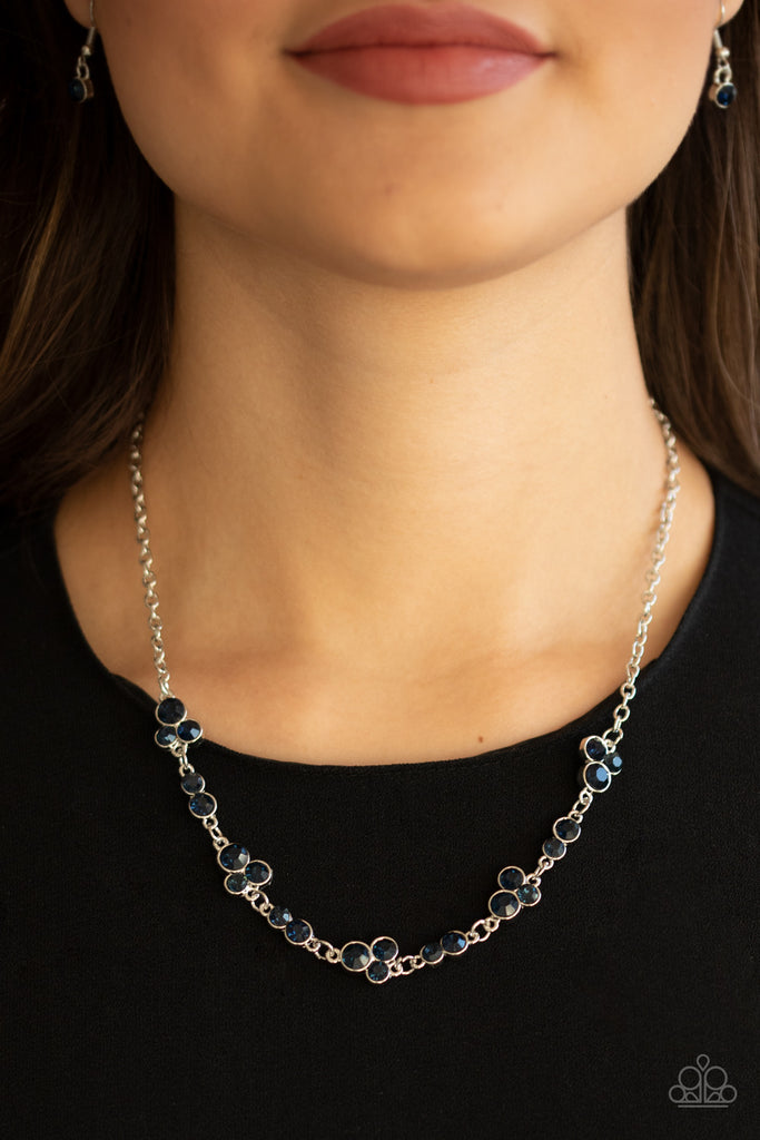 Encased in sleek silver frames, dainty pairs and trios of glittery blue rhinestones delicately link into a timeless display below the collar. Features an adjustable clasp closure.  Sold as one individual necklace. Includes one pair of matching earrings.