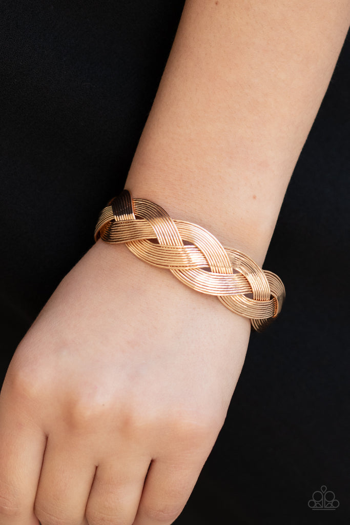 Attached to two glistening gold fittings, rows of dainty gold wire weave around the wrist, creating a boldly braided cuff.  Sold as one individual bracelet.  