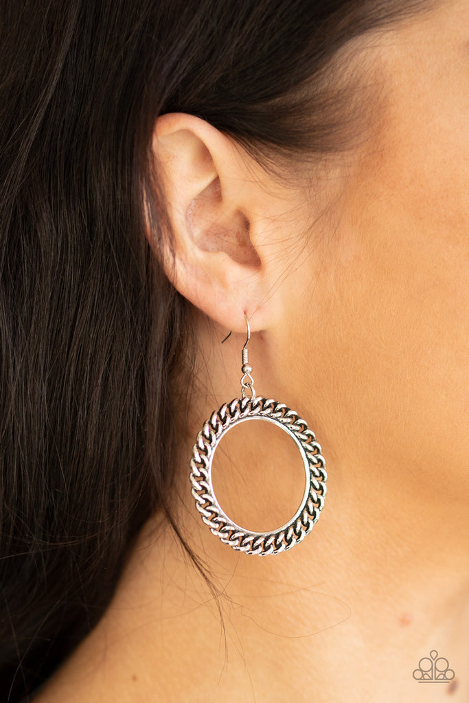 An edgy strand of silver chain wraps around a silver ring, coalescing into a bold industrial hoop. Earring attaches to a standard fishhook fitting.  Sold as one pair of earrings.