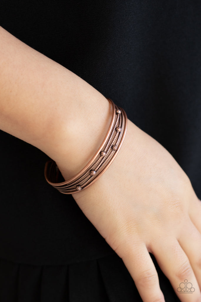 Dotted in ornate copper beads, textured copper wires layer between two smooth copper bars, stacking into an edgy cuff around the wrist.  Sold as one individual bracelet.  
