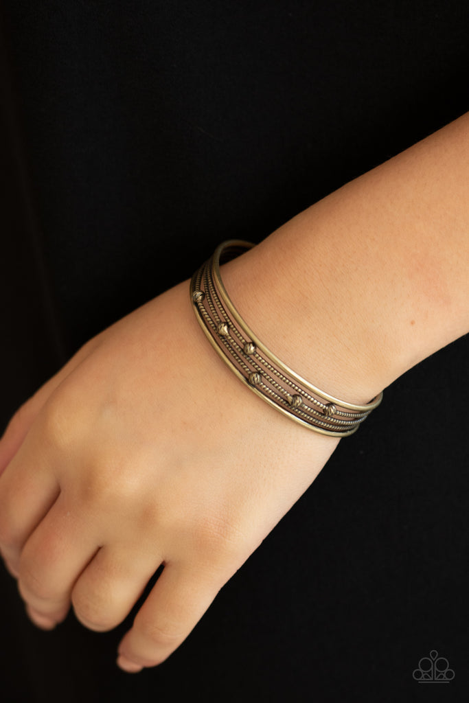 Dotted in ornate brass beads, textured brass wires layer between two smooth brass bars, stacking into an edgy cuff around the wrist.  Sold as one individual bracelet.