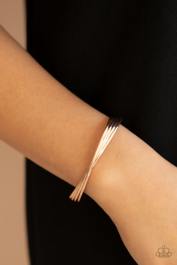 A stack of four glistening rose gold bars delicately twist at the center as they delicately layer into a dainty cuff around the wrist.  Sold as one individual bracelet.