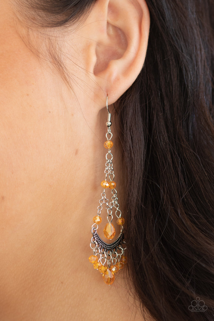Featuring an iridescent shimmer, a glittery collection of orange crystal-like beads link with shimmery silver chains that give way to a studded silver bar and colorful fringe. Earring attaches to a standard fishhook fitting.  Sold as one pair of earrings.