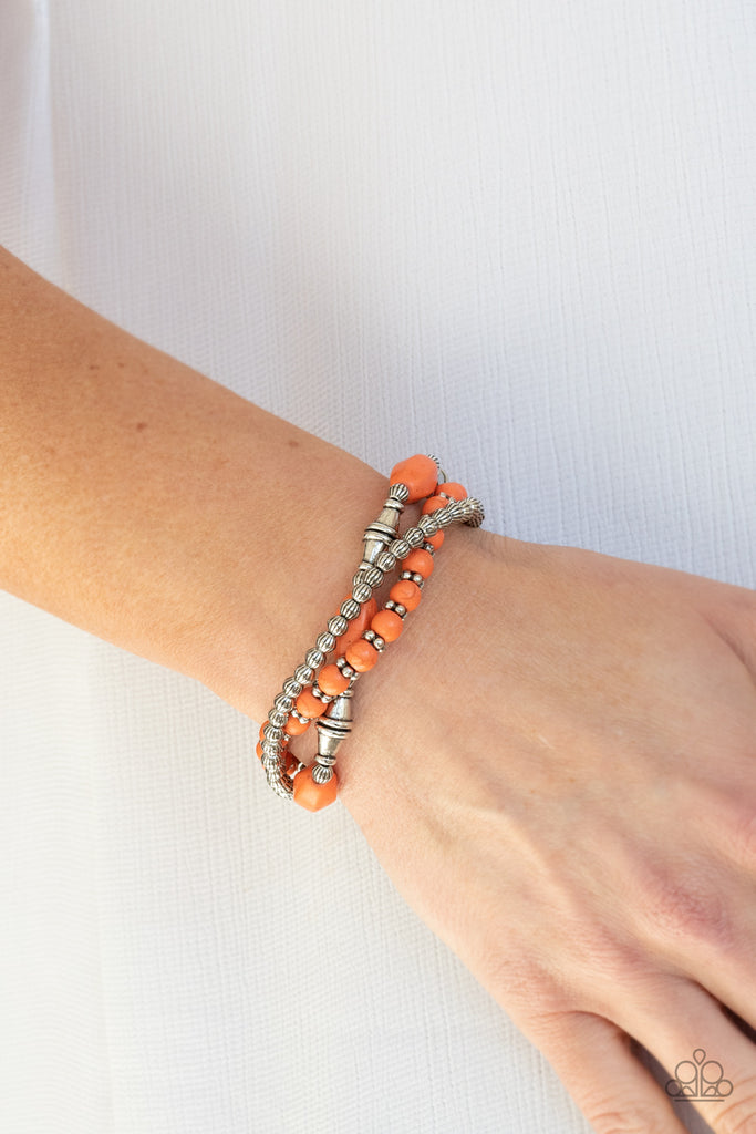 An earthy collection of mismatched orange stones and ornate silver beads are threaded along stretchy bands around the wrist for a colorful artisan flair.  Sold as one set of three bracelets.