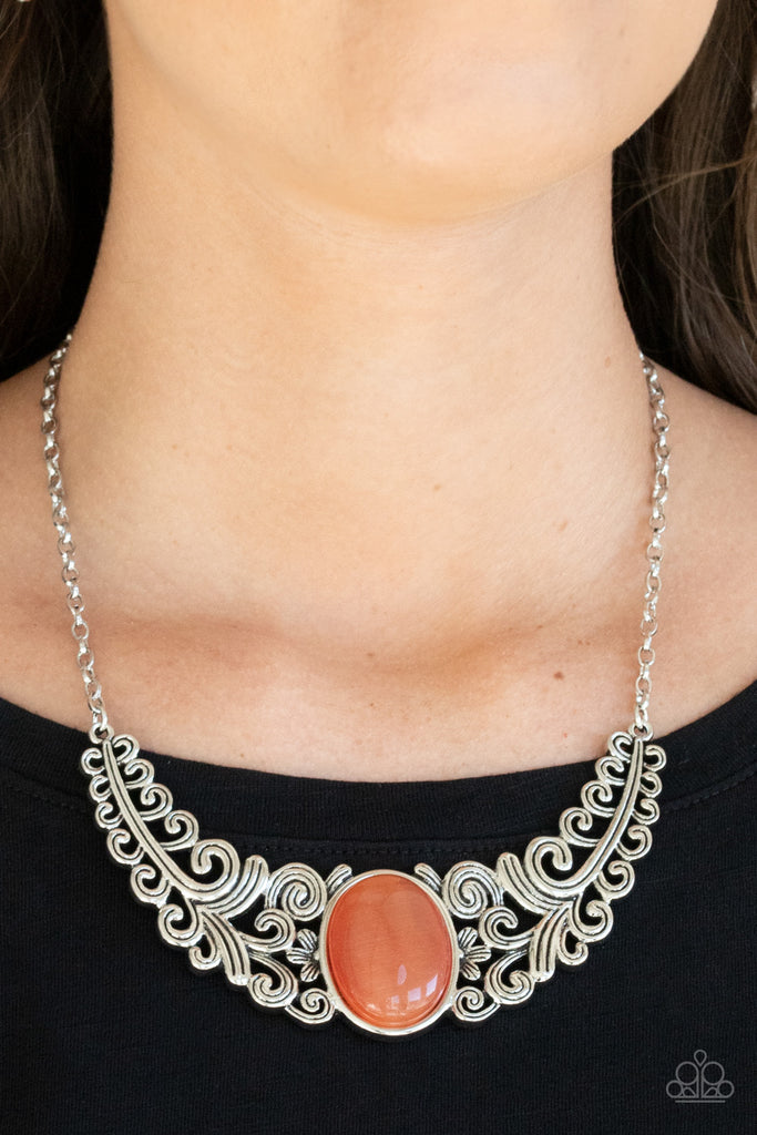 Featuring vine and floral details, leafy silver frames branch out from an oversized orange cat's eye stone center, creating a dramatically whimsical centerpiece below the collar. Features an adjustable clasp closure.  Sold as one individual necklace. Includes one pair of matching earrings.  
