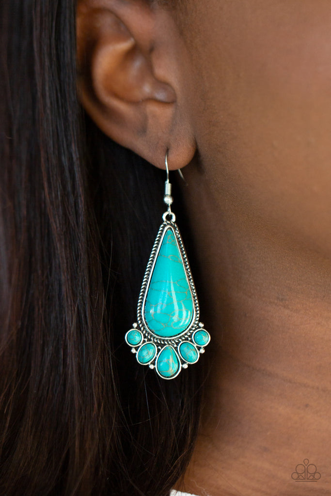 A dainty collection of round, oval, and teardrop turquoise stones fan out from the bottom of an oversized teardrop turquoise frame for a simple seasonal flair. Earring attaches to a standard fishhook fitting.  Sold as one pair of earrings.  New Kit