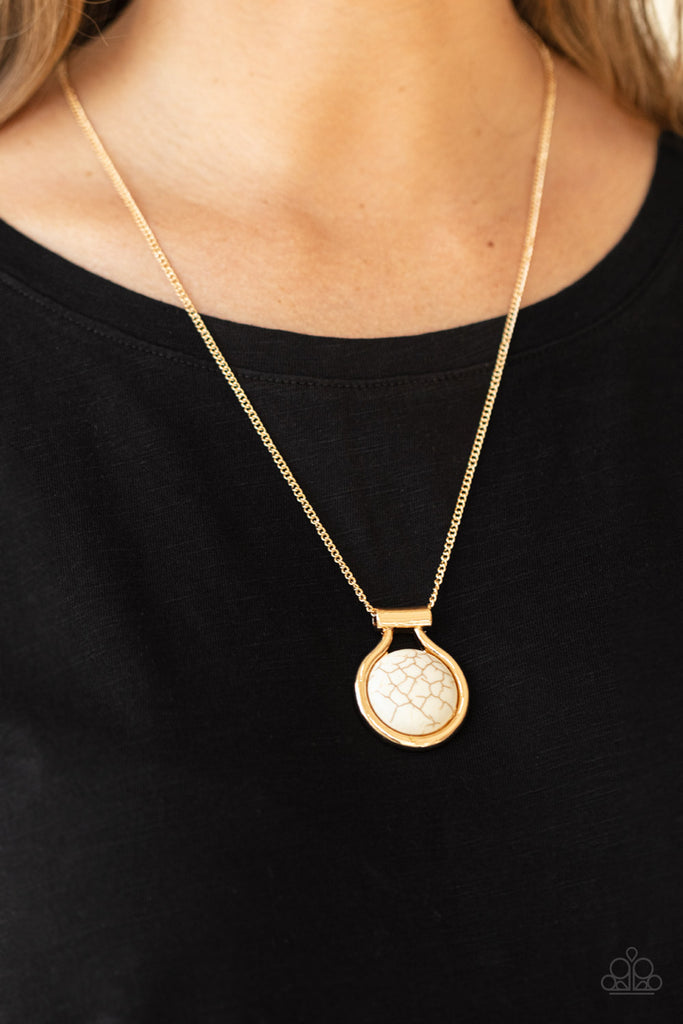 Encased in an artisan inspired gold fitting, a refreshing white stone pendant glides along a gold chain for a colorfully seasonal look. Features an adjustable clasp closure.  Sold as one individual necklace. Includes one pair of matching earrings.  New Kit