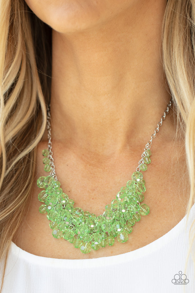 Row after row of glittery green crystal-like beads swing from interconnected strands of silver chain, creating a colorfully effervescent fringe below the collar. Features an adjustable clasp closure.  Sold as one individual necklace. Includes one pair of matching earrings.