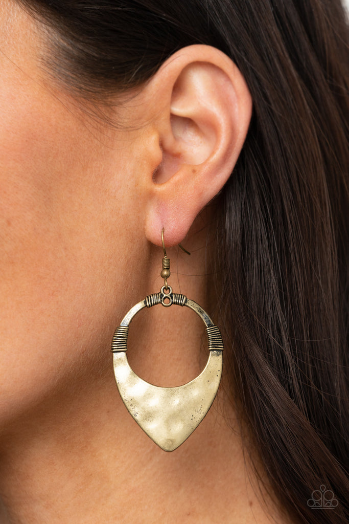 Featuring faux wire wrap details, a hammered brass teardrop-like frame swings from the ear for an artisan inspired look. Earring attaches to a standard fishhook fitting.  Sold as one pair of earrings.