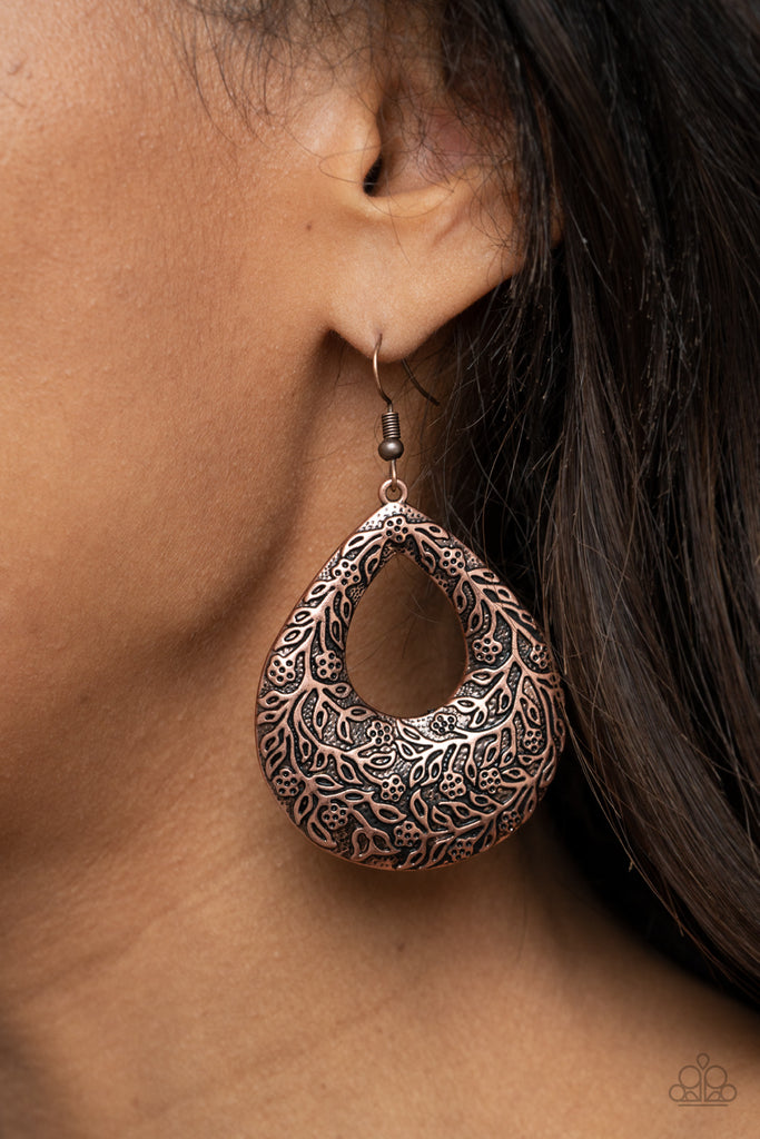 Antiqued floral filigree is embossed across the front of an oversized copper teardrop, creating a whimsical frame. Earring attaches to a standard fishhook fitting.  Sold as one pair of earrings.  