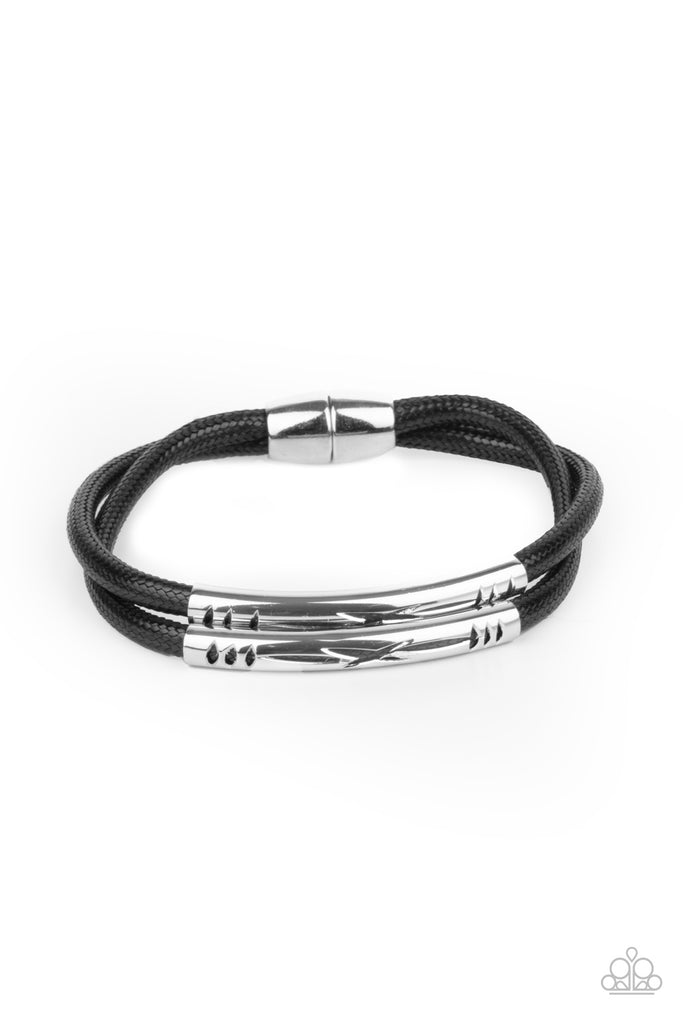 Featuring tribal inspired cutouts, stenciled silver bars slide along two shiny black cords around the wrist for an adventurous look. Features a magnetic closure.  Sold as one individual bracelet.  