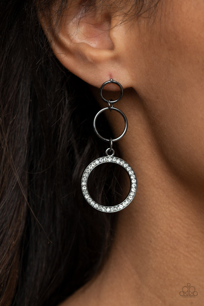 Two dainty gunmetal rings give way to a white rhinestone encrusted gunmetal hoop, adding a timeless twist to the dazzling display. Earring attaches to a standard post fitting.  Sold as one pair of post earrings.  