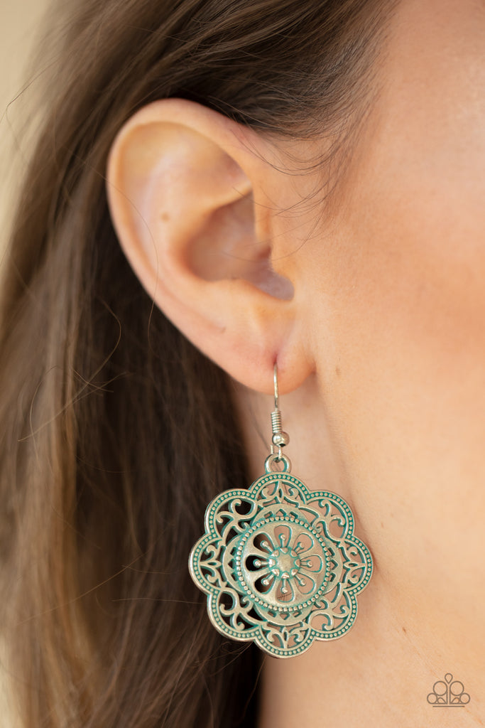 Featuring a rustic patina finish, a decorative mandala-like silver frame swings from the ear for a whimsical look. Earring attaches to a standard fishhook fitting.  Sold as one pair of earrings.