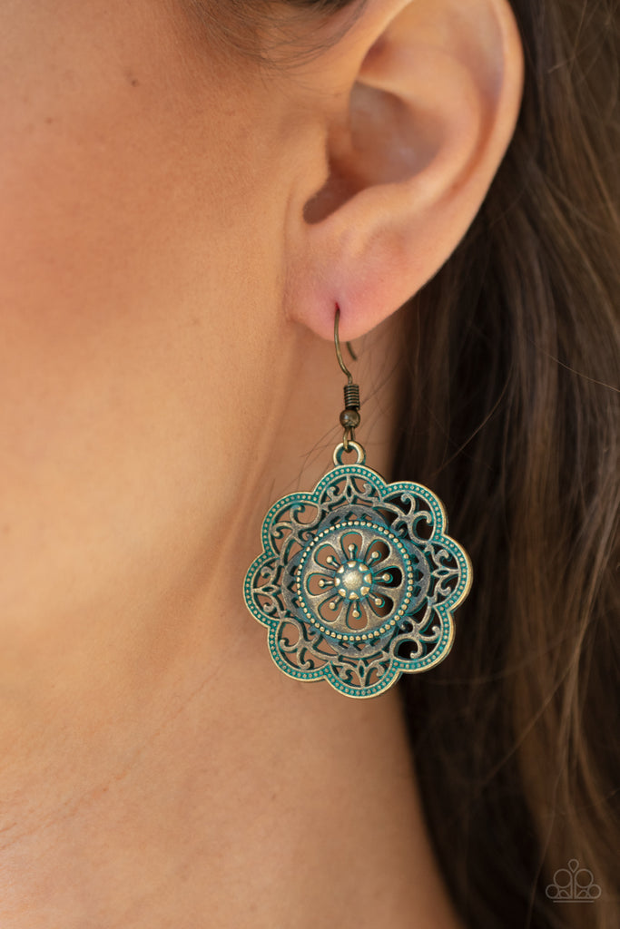 Featuring a rustic patina finish, a decorative mandala-like brass frame swings from the ear for a whimsical look. Earring attaches to a standard fishhook fitting.  Sold as one pair of earrings.
