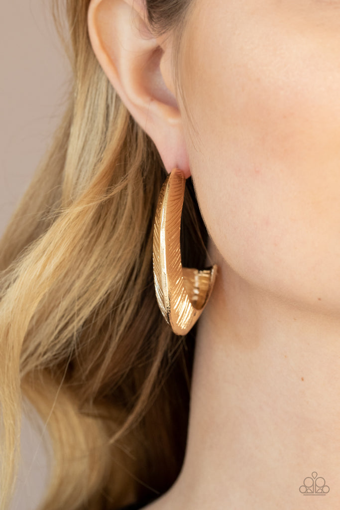 Etched in sporadic linear patterns, two shimmery gold frames join into a hollow hook that flares out into an eye-catching hoop. Earring attaches to a standard post fitting. Hoop measures approximately 1 1/2" in diameter.  Sold as one pair of hoop earrings.