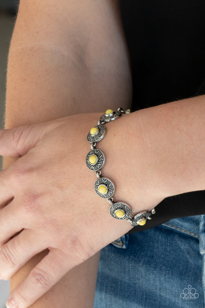 Dotted with sunny Illuminating beaded centers, dainty floral embossed silver frames delicately link around the wrist for a colorful springtime look. Features an adjustable clasp closure.  Sold as one individual bracelet.