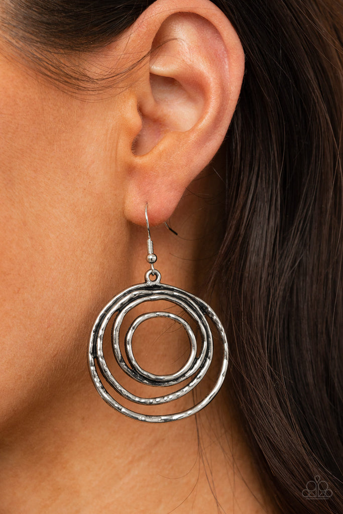 Brushed in an antiqued shimmer, hammered silver wire coils into a dizzying frame for an edgy industrial look. Earring attaches to a standard fishhook fitting.  Sold as one pair of earrings.  