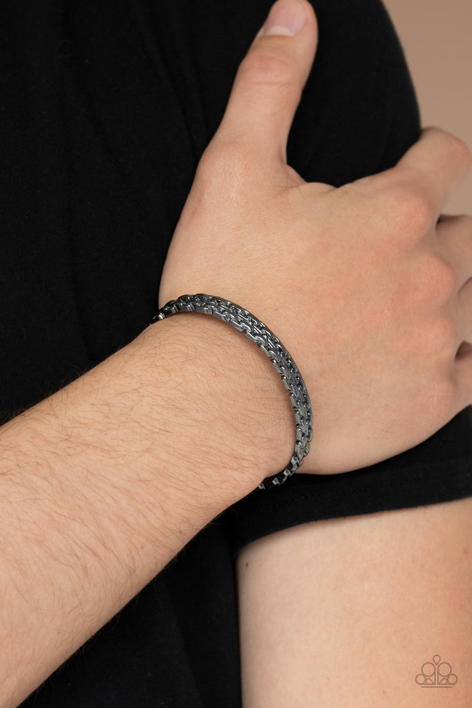 The front of a shiny gunmetal cuff is embossed into two rows of interlocking gunmetal chains, creating a gritty look around the wrist.  Sold as one individual bracelet.  