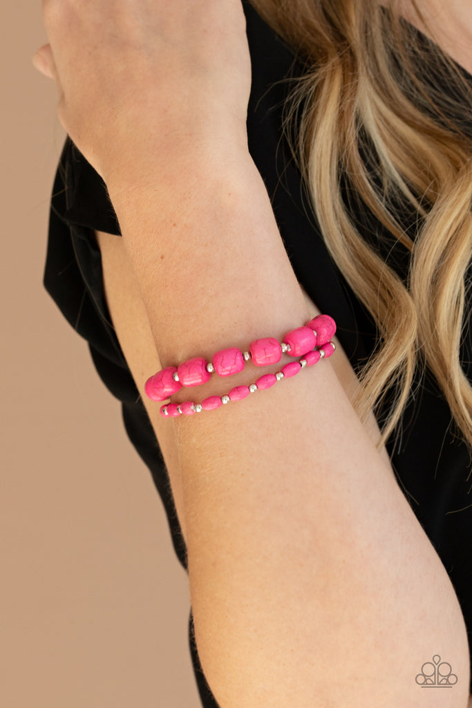 Dainty silver beads and mismatched pink stone beads are threaded along stretchy bands around the wrist, creating vivacious layers.  Sold as one pair of bracelets.  