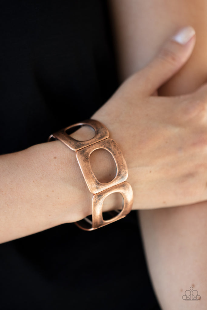 Brushed in a gritty finish, airy ovals have been cut out of curved copper frames. Threaded along stretchy bands around the wrist, the airy frames allow the skin to peek through their centers for a natural finish.  Sold as one individual bracelet.