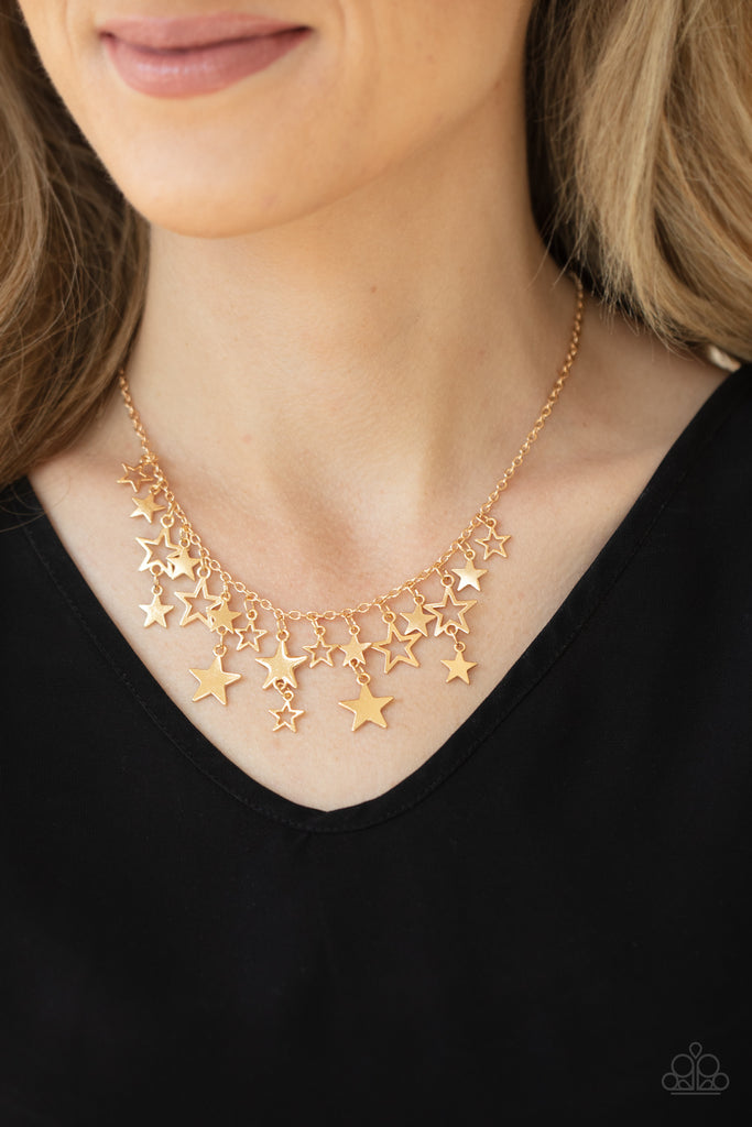 A mismatched collection of shiny gold stars cascade from a dainty gold chain, creating a stellar fringe below the collar. Features an adjustable clasp closure.  Sold as one individual necklace. Includes one pair of matching earrings.