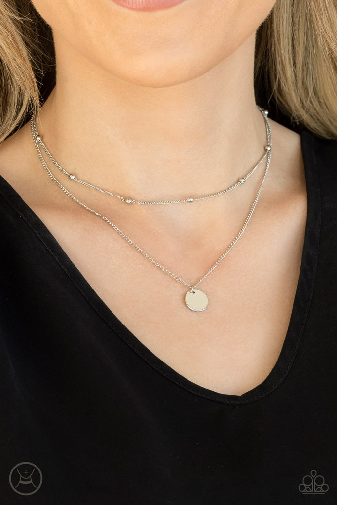 Infused with a silver beaded chain, a dainty silver disc slides along a classic silver chain around the neck, creating sleek layers. Features an adjustable clasp closure.  Sold as one individual choker necklace. Includes one pair of matching earrings.