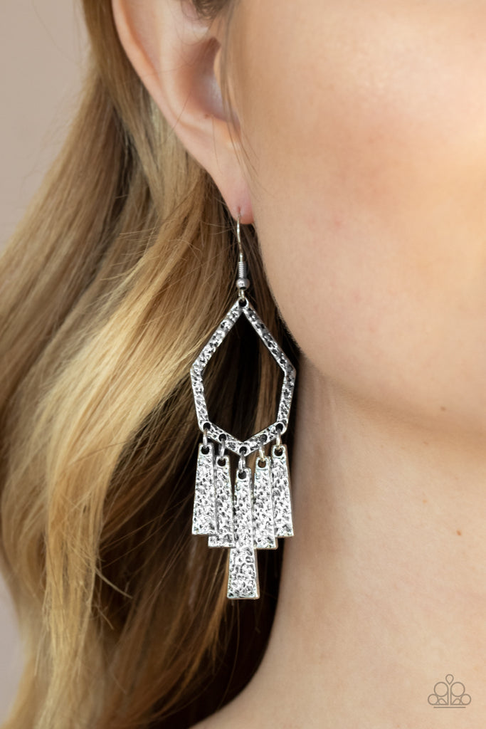 Hammered in shimmery detail, flared rectangular frames swing from the bottom of a geometric silver frame for a rustic flair. Earring attaches to a standard fishhook fitting.  Sold as one pair of earrings.