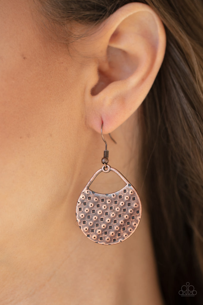The front of a uniquely shaped copper frame is stamped and hammered in slanting rows of square and dotted patterns for a one-of-a-kind look. Earring attaches to a standard fishhook fitting.  Sold as one pair of earrings.