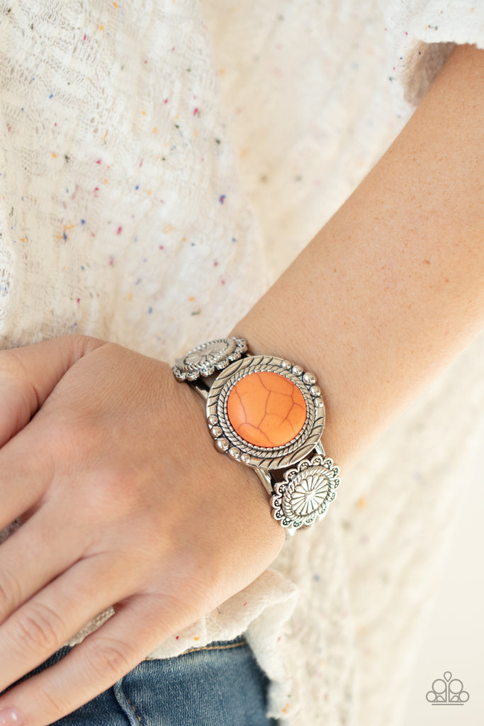Flanked by two studded silver floral frames, an oversized orange stone adorns the center of a layered silver cuff for an authentic southwestern flair.  Sold as one individual bracelet.  