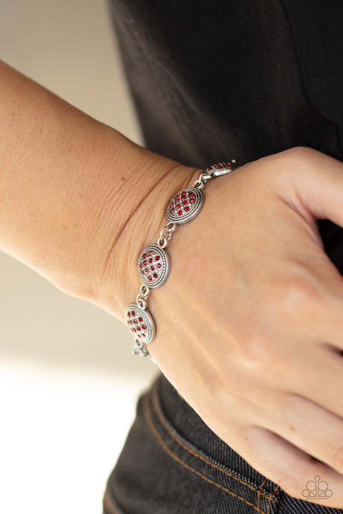 Dotted with fiery red rhinestones, studded silver frames delicately connect around the wrist for a royal flair. Features an adjustable clasp closure.  Sold as one individual bracelet.
