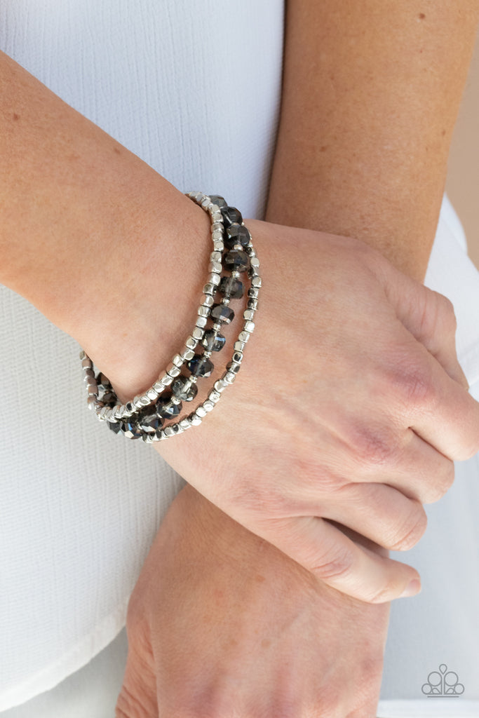A pair of silver cube beads join one strand of hematite crystal-like beads around the wrist, creating iridescent stretchy layers.  Sold as one set of three bracelets.  New Kit