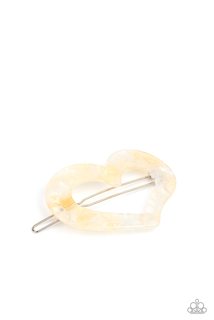Flecked in iridescent shell-like shimmer, an acrylic heart frame pulls back the hair in a flirty fashion. Features a clamp barrette closure.  Sold as one individual hair clip.