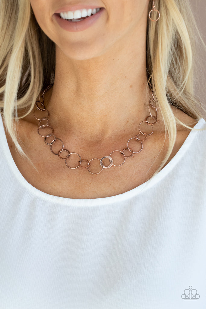 Dainty copper hoops and rustic rings delicately link into a chic chain, creating simplistic shimmer below the collar. Features an adjustable clasp closure.  Sold as one individual necklace. Includes one pair of matching earrings.  New Kit