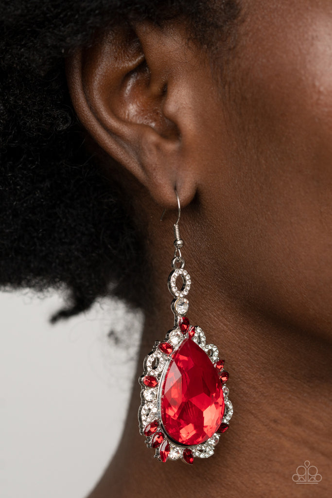 Featuring round, teardrop, and oval shapes, red and white rhinestone encrusted filigree borders a dramatically oversized red rhinestone teardrop for a jaw-dropping dazzle. Earring attaches to a standard fishhook fitting.  Sold as one pair of earrings.