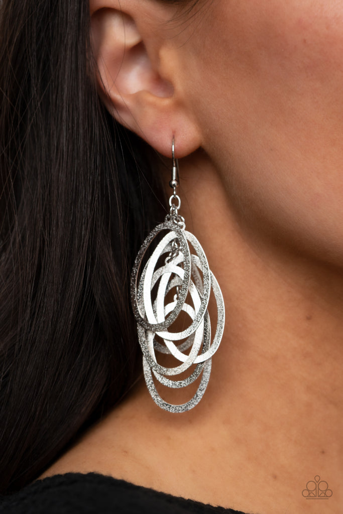 Featuring a hammered high sheen finish, flat silver ovals cascade from the ear, creating a flattering tassel. Earring attaches to a standard fishhook fitting.  Sold as one pair of earrings.