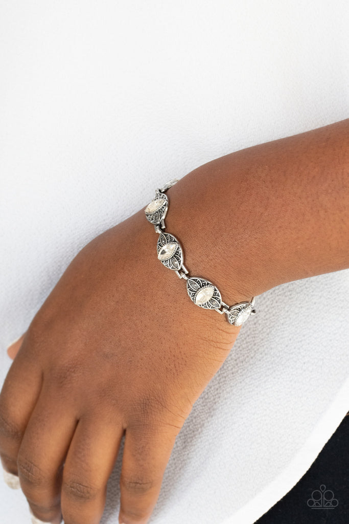 Featuring white marquise rhinestone centers, silver studded floral frames are dotted in dainty hematite rhinestones as they link around the wrist for a regal flair. Features an adjustable clasp closure.  Sold as one individual bracelet.