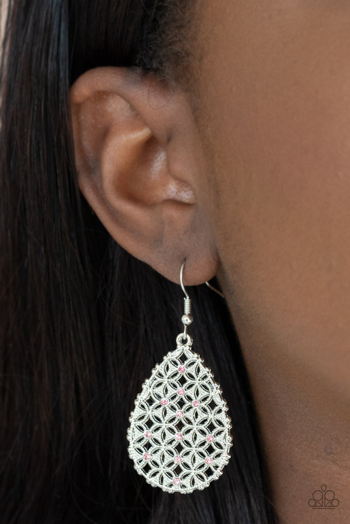 Dainty pink rhinestones are encrusted across the front of a silver teardrop frame filled with ornate tactile filigree, creating a whimsical lure. Earring attaches to a standard fishhook fitting.  Sold as one pair of earrings.  