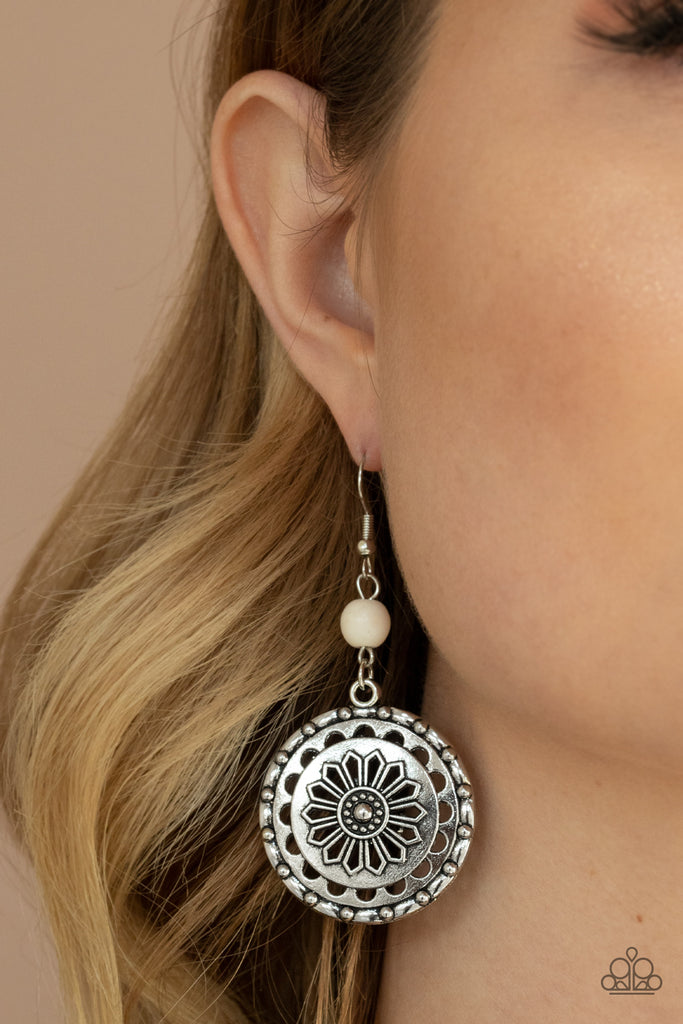 A refreshing white stone bead gives way to a studded silver frame embossed in a whimsical daisy pattern, creating a rustic lure. Earring attaches to a standard fishhook fitting.  Sold as one pair of earrings.
