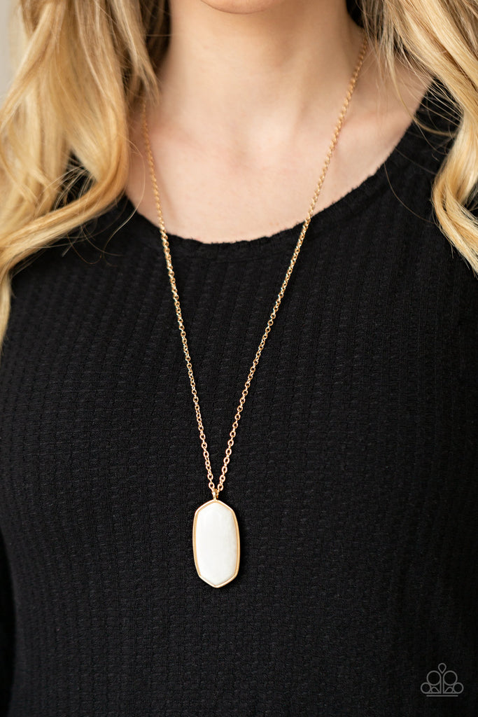 Encased in a classic gold fitting, a glassy white stone swings from the bottom of a lengthened gold chain for an elegantly earthy look. Features an adjustable clasp closure.  Sold as one individual necklace. Includes one pair of matching earrings.  