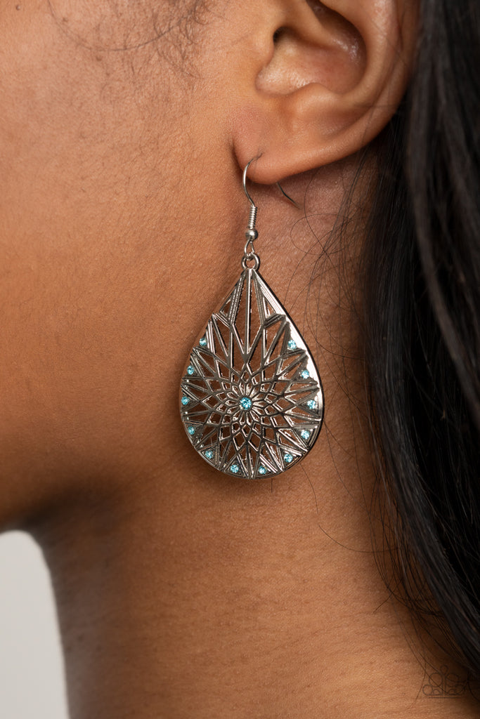Featuring a shattered snowflake pattern, the front of an airy silver teardrop is adorned in dainty blue rhinestones for an icy finish. Earring attaches to a standard fishhook fitting.  Sold as one pair of earrings.