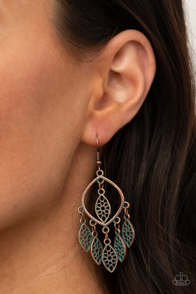 Brushed in a patina finish, dainty floral copper frames swing from the bottom and top of an airy copper frame, creating a rustic fringe. Earring attaches to a standard fishhook fitting.  Sold as one pair of earrings.