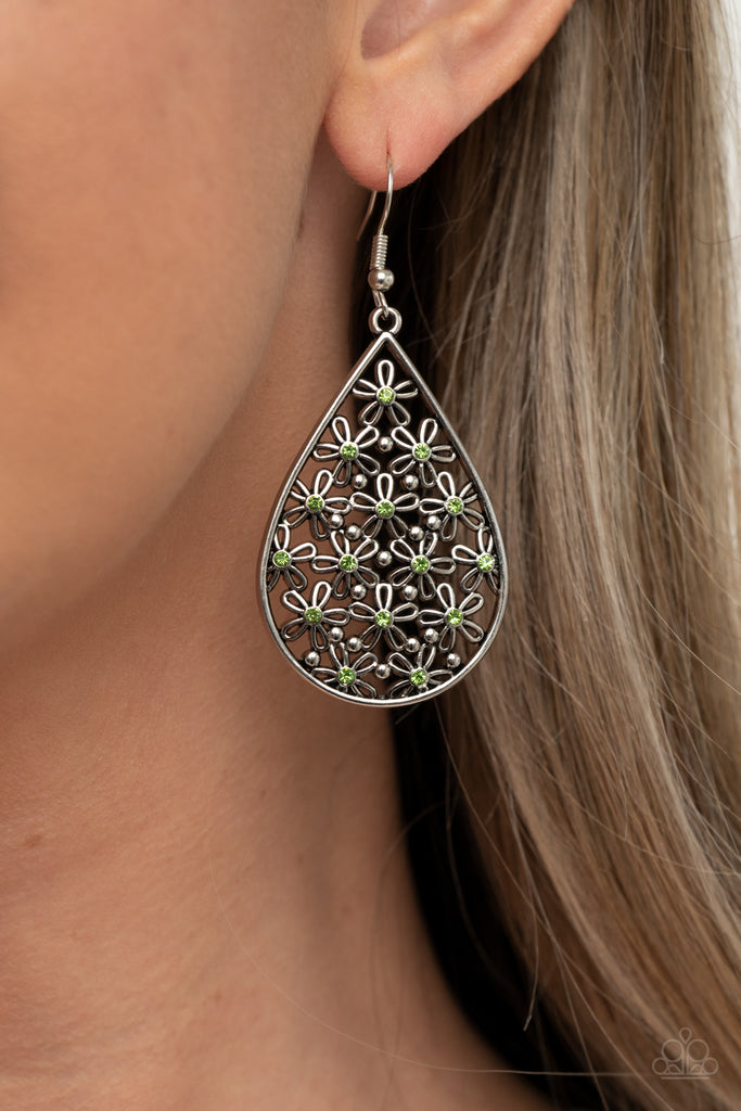 Featuring dainty green rhinestone centers, airy silver flowers and dainty silver studs coalesce inside a teardrop frame for a whimsical look. Earring attaches to a standard fishhook fitting.  Sold as one pair of earrings.