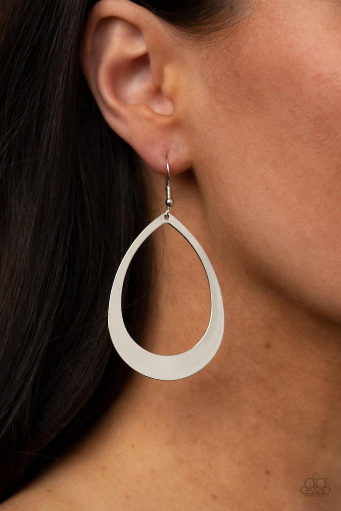 Widening at the bottom, a flat glistening silver teardrop swings from the ear for a simplistic shimmer. Earring attaches to a standard fishhook fitting.  Sold as one pair of earrings.