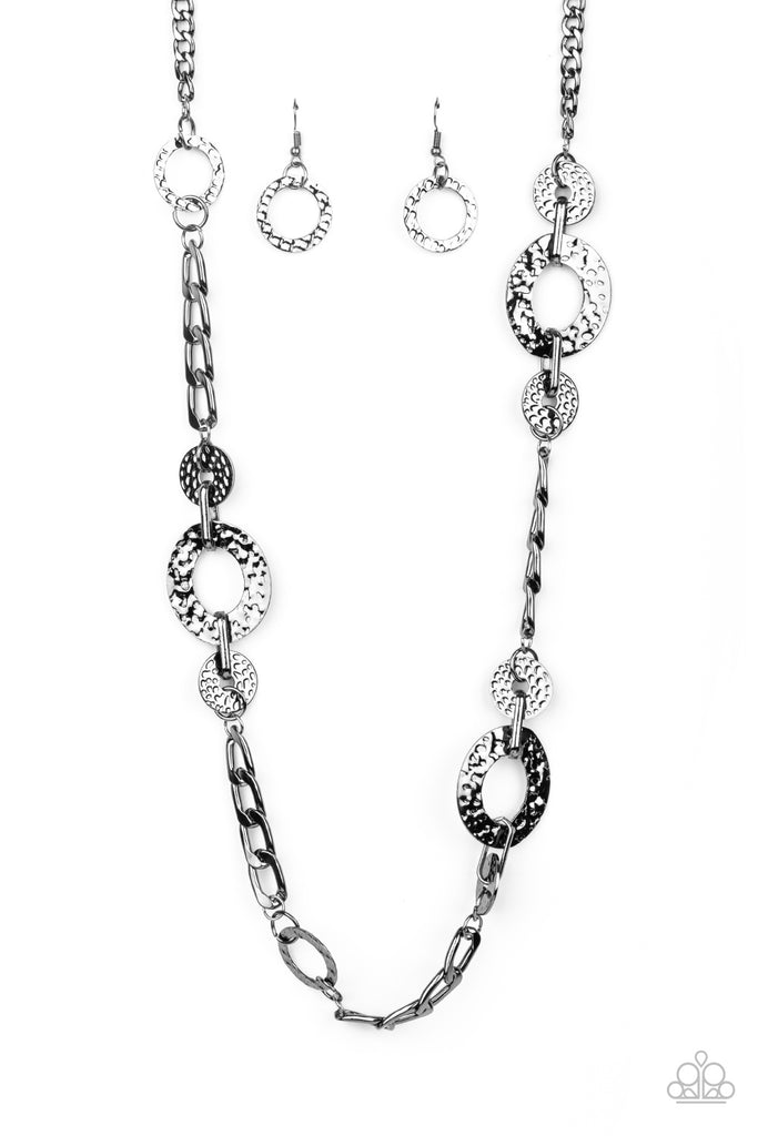 mechanically-metro-black  A hammered collection of gunmetal discs, gunmetal rings, and sections of chunky gunmetal chain boldly link across the chest for an intense industrial style. Features an adjustable clasp closure.  Sold as one individual necklace. Includes one pair of matching earrings.