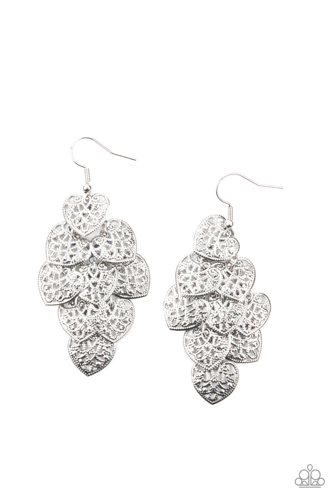 shimmery-soulmates-silver Featuring studded filigree filled centers, rustic silver heart frames cascade from the ear as they link into a flawless overlapping lure. Earring attaches to a standard fishhook fitting.  Sold as one pair of earrings.  