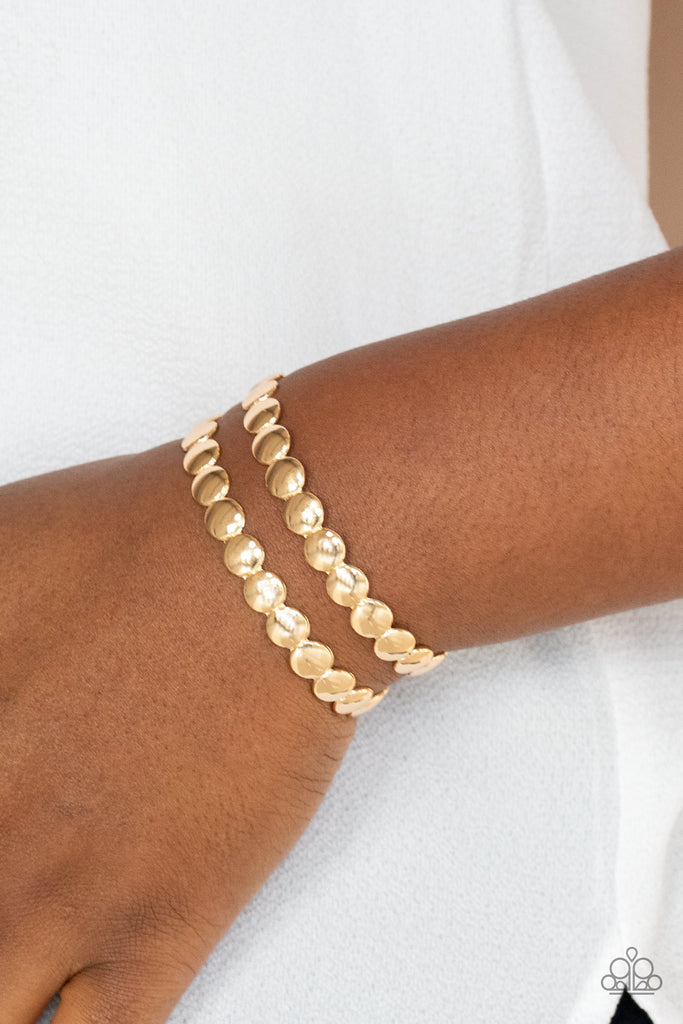 Brushed in a shiny finish, rows of flattened gold studs coalesce into a shimmery cuff around the wrist.  Sold as one individual bracelet.